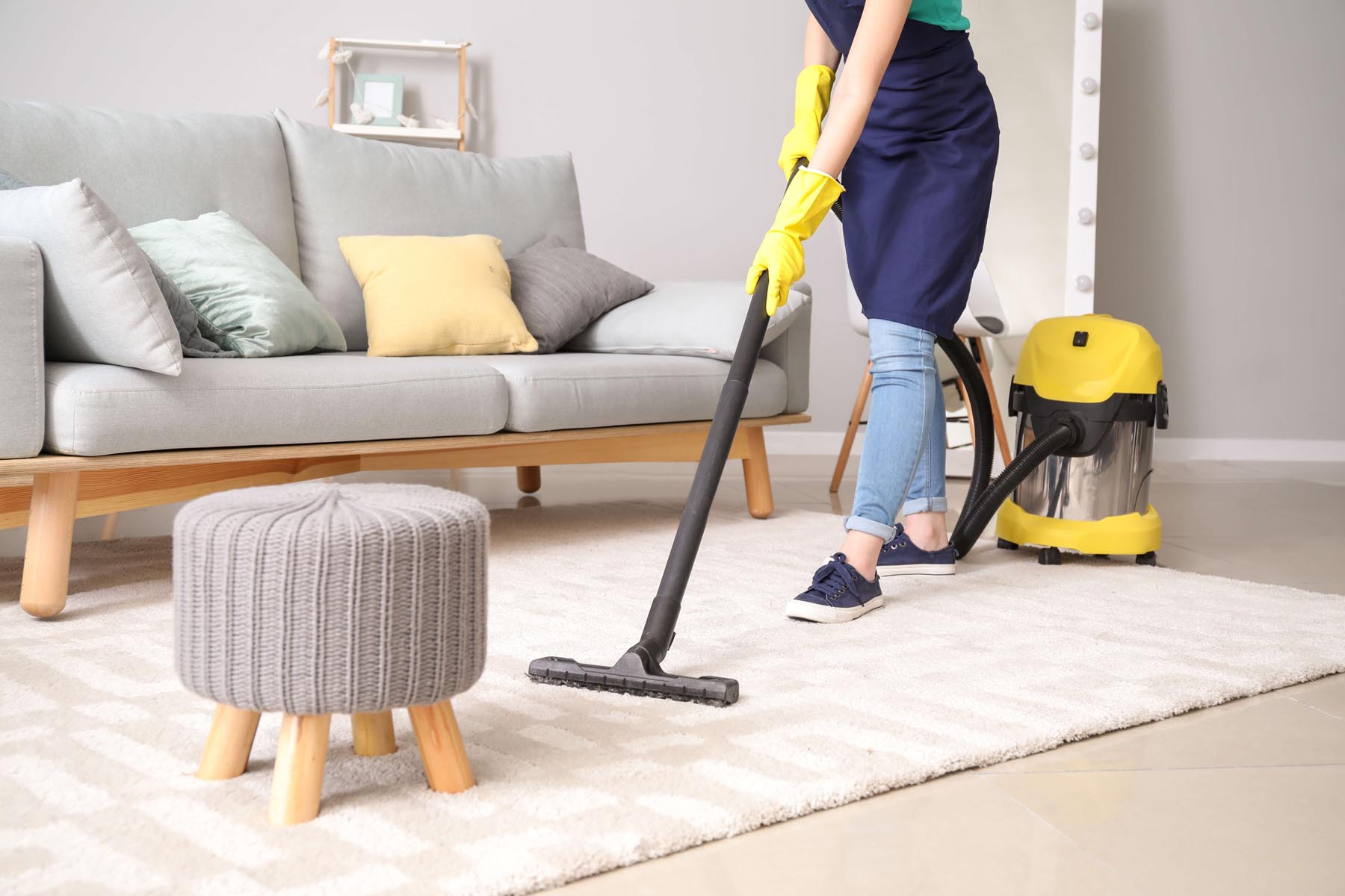 Professional house cleaner making bed